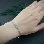 Mille - srebrna regulowana bransoletka z opalem i wzorem flora